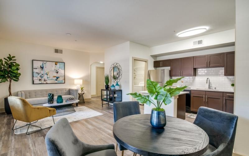 a living room with a table and chairs