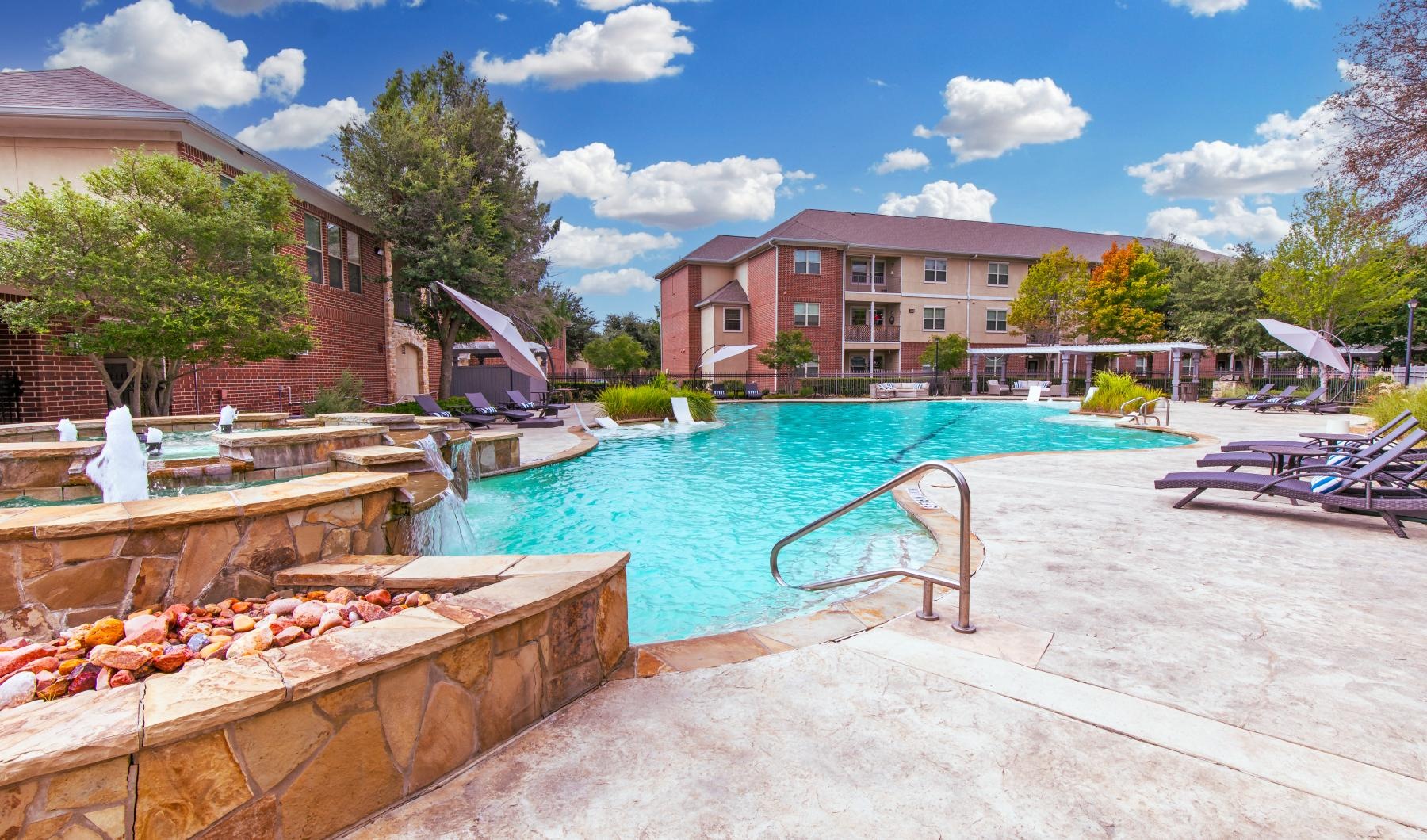 a pool with a deck and chairs